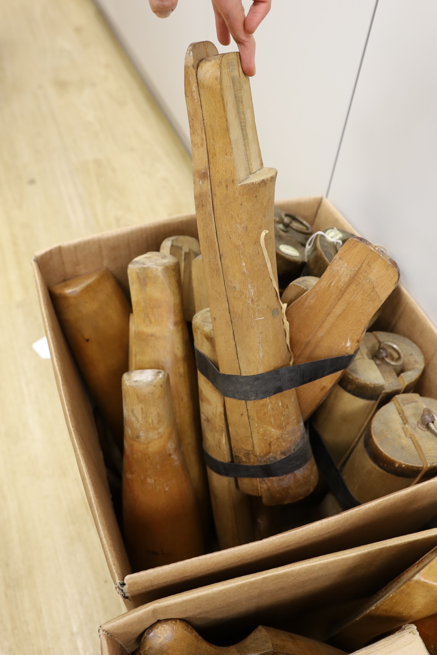 An assortment of beech boot-trees and folding boot hooks